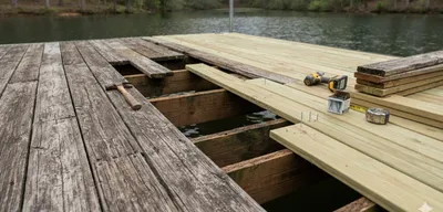 Boat dock repair with new decking replacing weathered planks