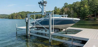 Vertical boat lift with recreational boat on residential dock